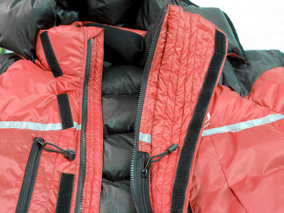 Jacket showed flared over-baffle (to protect water drips from oxygen-mask freezing on zip) Jacket showed flared over-baffle (to protect water drips from oxygen-mask freezing on zip)
