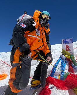 Michael Woods atop Everest in a PHD Omega Down Suit